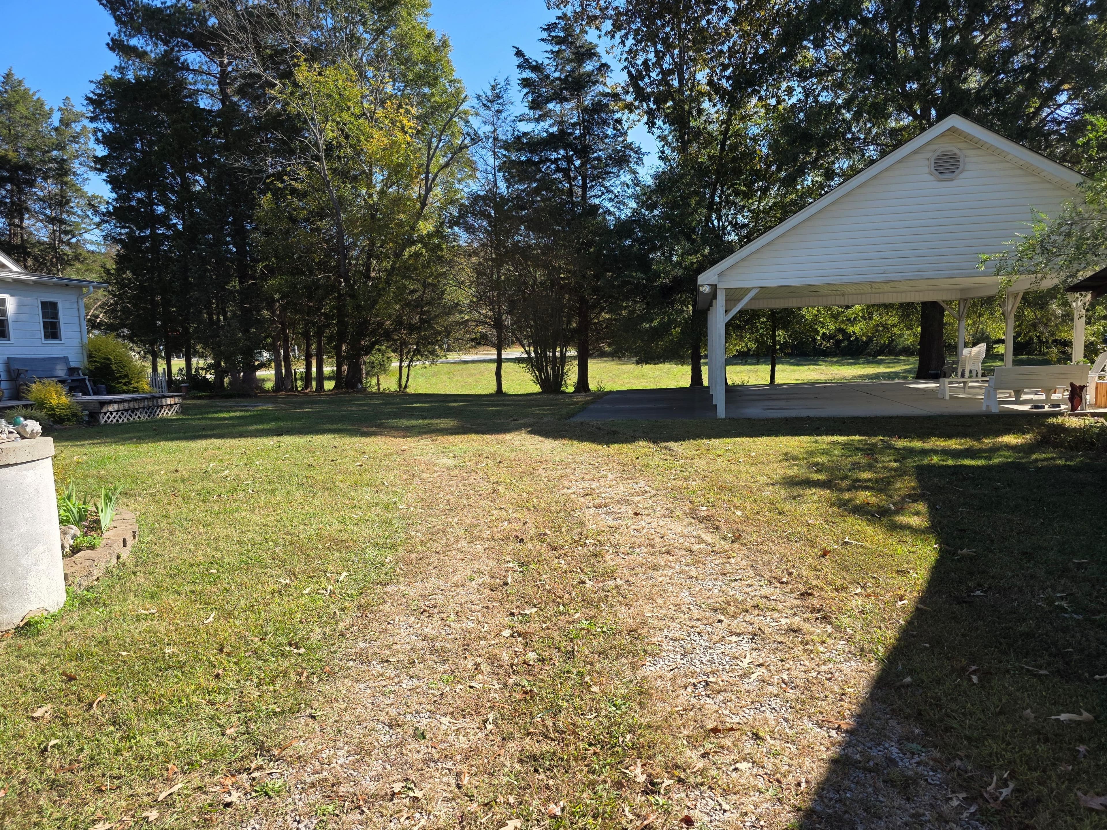 Grassy driveway area before gravel driveway repair and stone placement