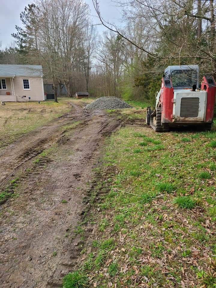 Muddy driveway area before gravel driveway repair and regrading