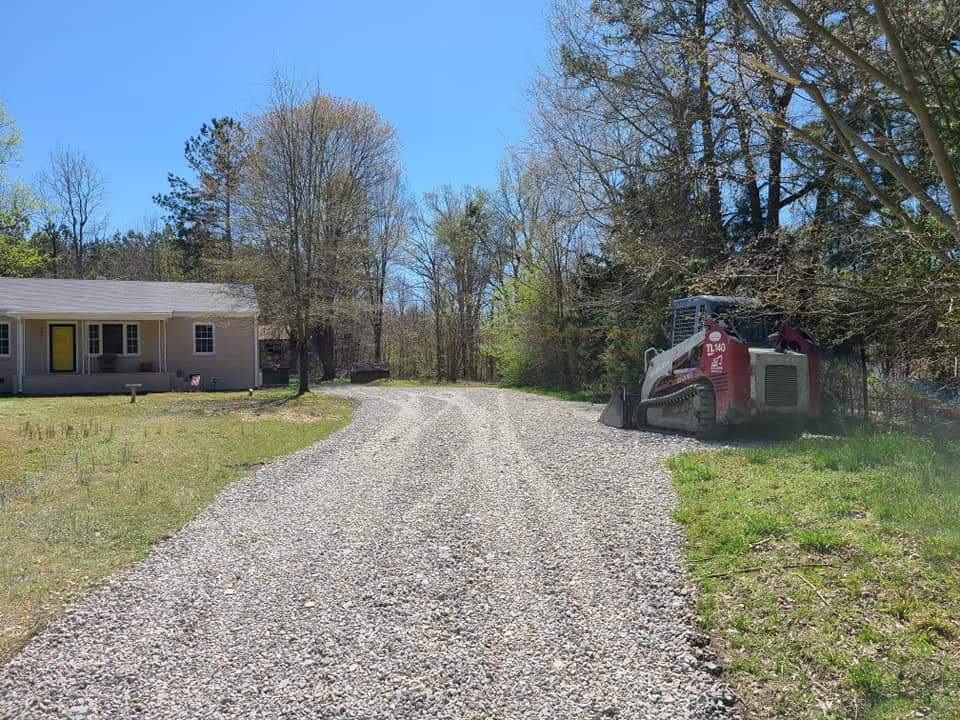 Gravel driveway after grading with Skidsteer on site