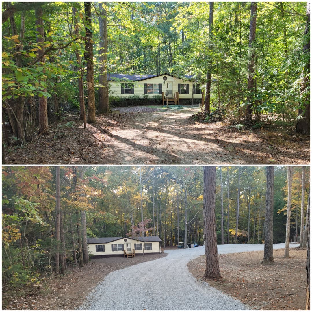 Cozy home nestled in the woods with gravel driveway surrounded by trees in autumn.